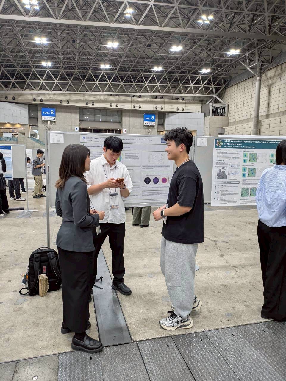 Researchers discussing posters at JpGU 2026.